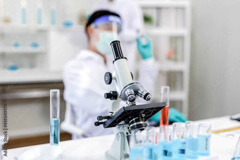Microscope image and scientist background Microscope image and scientist background