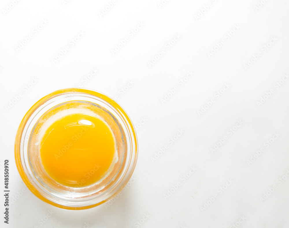 Minimalism, an egg in a pot, on a white background. The testicle is in the lower left corner. top view
