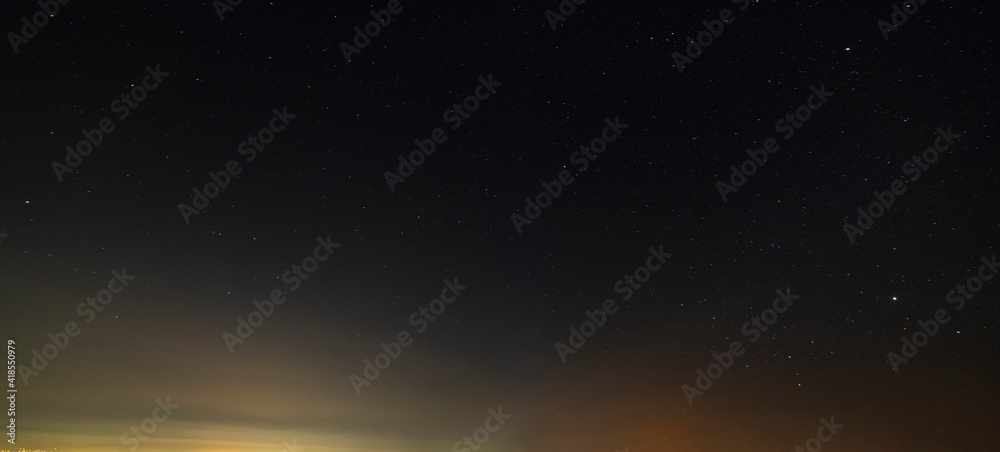 Fototapeta premium Beautiful winter dark starry sky. Night photography, astronomical background.
