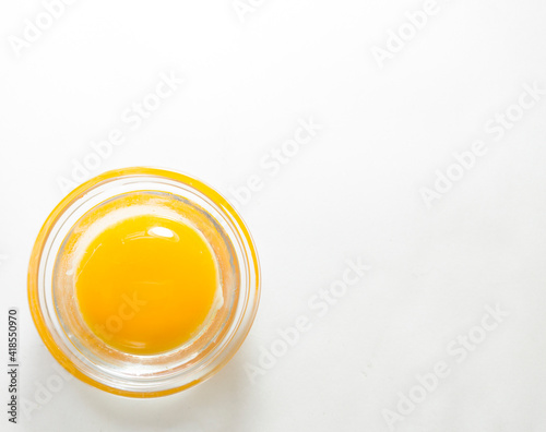 Minimalism, an egg in a pot, on a white background. The testicle is in the lower left corner. top view © Yelena