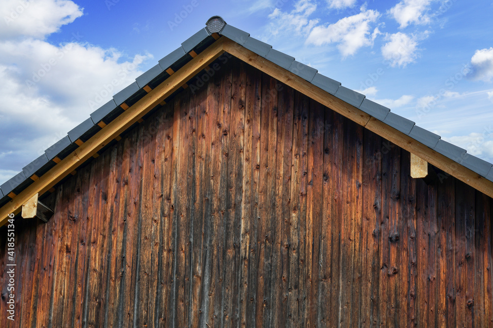 Old wooden house with weathered boards photographed in the forest