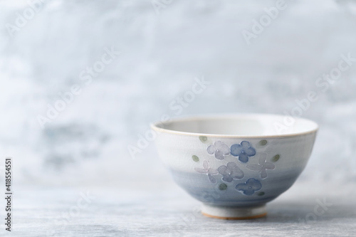 Traditional ceramic bowl on bright background. Copy space.	
