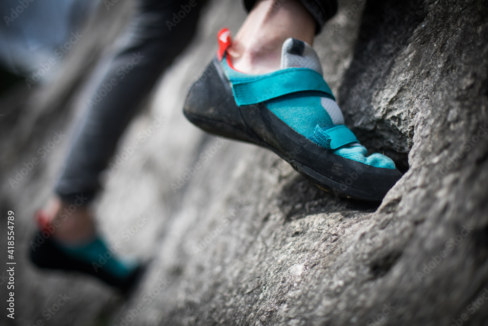 Person climbing while wearing rock climbing shoes