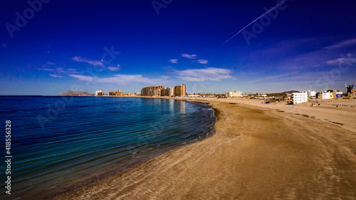 Aerial view of Sandy Beach, Puerto Penasco, Sonora, Mexico on the Sea of Cortez on a winter day with blue sky, aqua water and white clouds