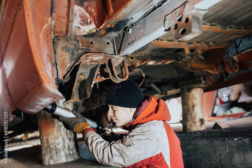 sealing of welded seams of a car with a sealant, body repair of transport.