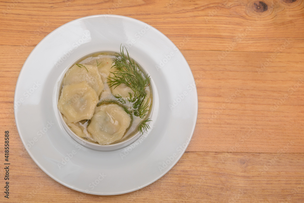 Homemade meat dumplings with broth and sour cream. View from above, copy space Homemade meat dumplings with broth and sour cream. View from above, copy space