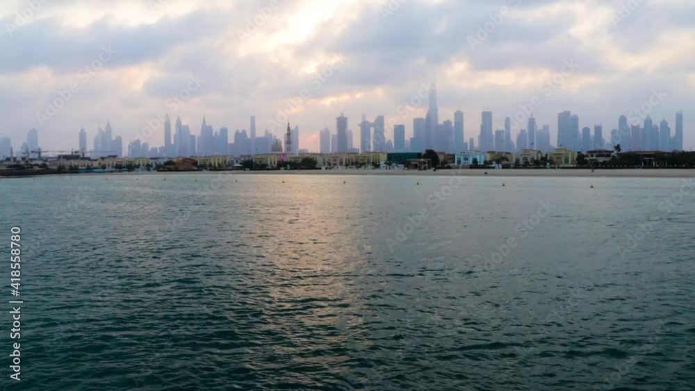 Dubai, UAE - 03.06.2021 Dubai public beach with city skyline on background. Sunrise hour. Outdoor Dubai, UAE - 03.06.2021 Dubai public beach with city skyline on background. Sunrise hour. Outdoor