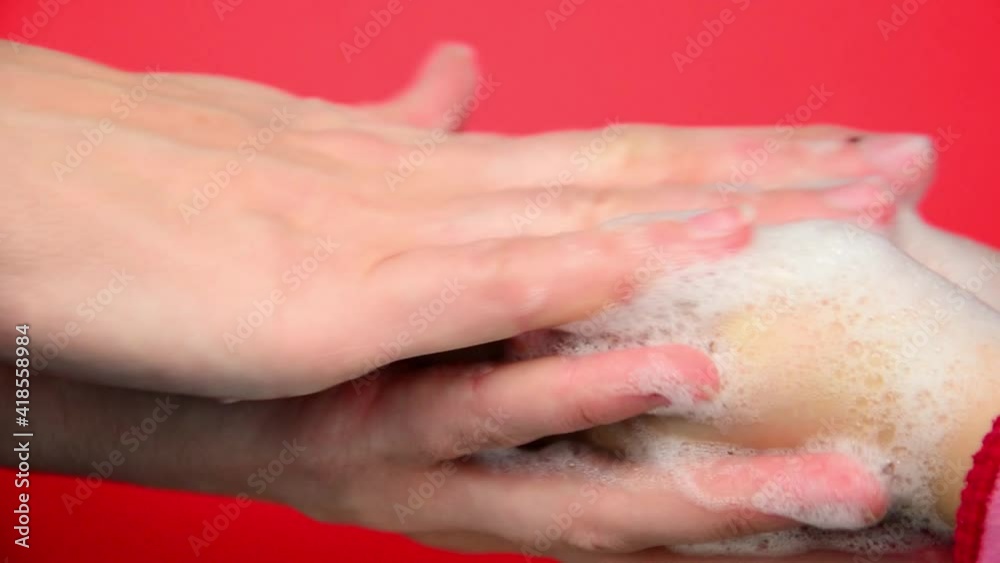 Hands of mother and child in foam. The mother washes her baby's hands. A child with his mother washes his hands during the coronavirus pandemic. Washing hands for a child. Hand dysenfection concept. Hands of mother and child in foam. The mother washes her baby's hands. A child with his mother washes his hands during the coronavirus pandemic. Washing hands for a child. Hand dysenfection concept.