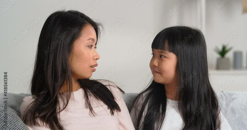 Portrait of two people asian young mother nanny listens attentively information from little brunette girl korean child share news tells private secrets, family trust and love home casual conversation Portrait of two people asian young mother nanny listens attentively information from little brunette girl korean child share news tells private secrets, family trust and love home casual conversation