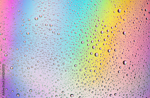 Texture of droplets on a rainbow background