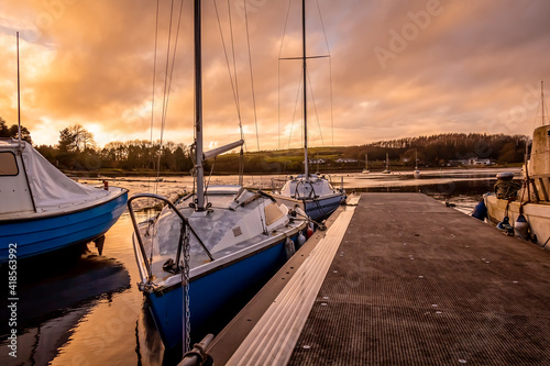 Yachts moored at Kirkcudbright marina at sunset in winter on the Dee estuary