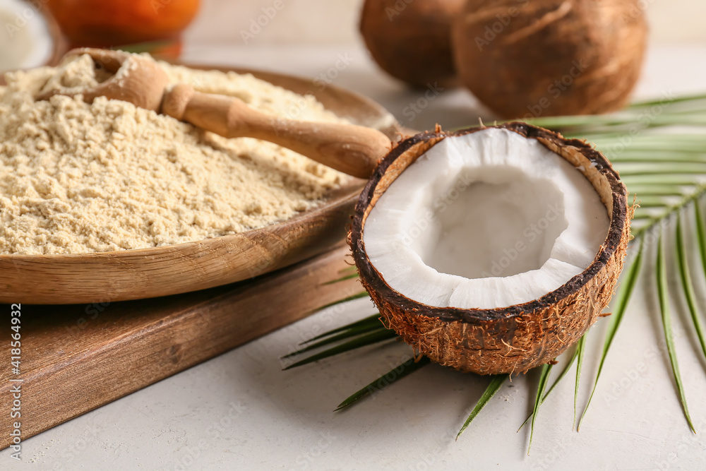 Plate with coconut flour on light background Plate with coconut flour on light background