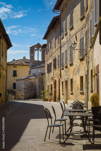 The main alley with the church of Santa Maria Assunta, San Quirico d'Orcia, Italy