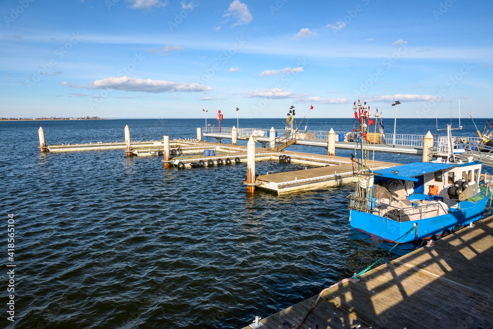 Fototapeta premium Fishong pier in Mechelinki. Mechelinki is a fishing village and a popular tourist destination on the Baltic Sea in Poland