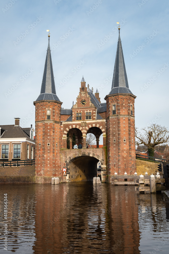 View of the historic Waterport gate with water reflection in a Dutch town of Sneek