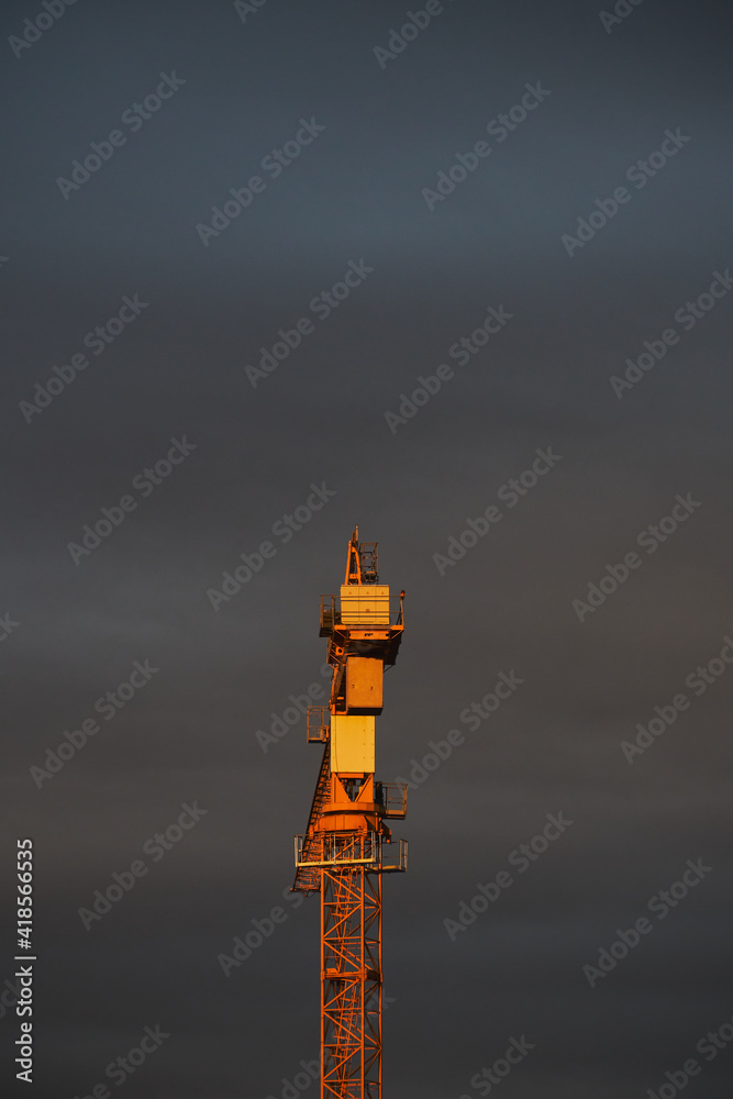 crane at sunset with clouds in the sky