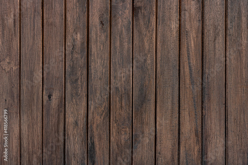 Texture of rural stained exterior vertical oak planks of country barn. Old dirty rough of gnarled surface wooden panel parquet.Rustic messy grungy lumber fence of hard laths for 3D siding style design