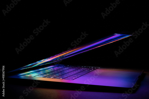 a laptop half closed bright and glowing