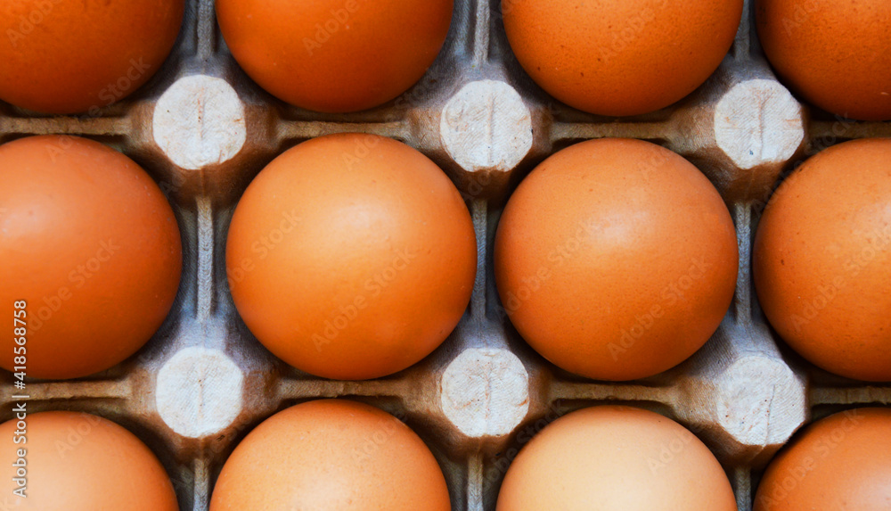 brown chicken eggs in cells. breakfast food. background for decoration for the Easter holiday. brown chicken eggs in cells. breakfast food. background for decoration for the Easter holiday.