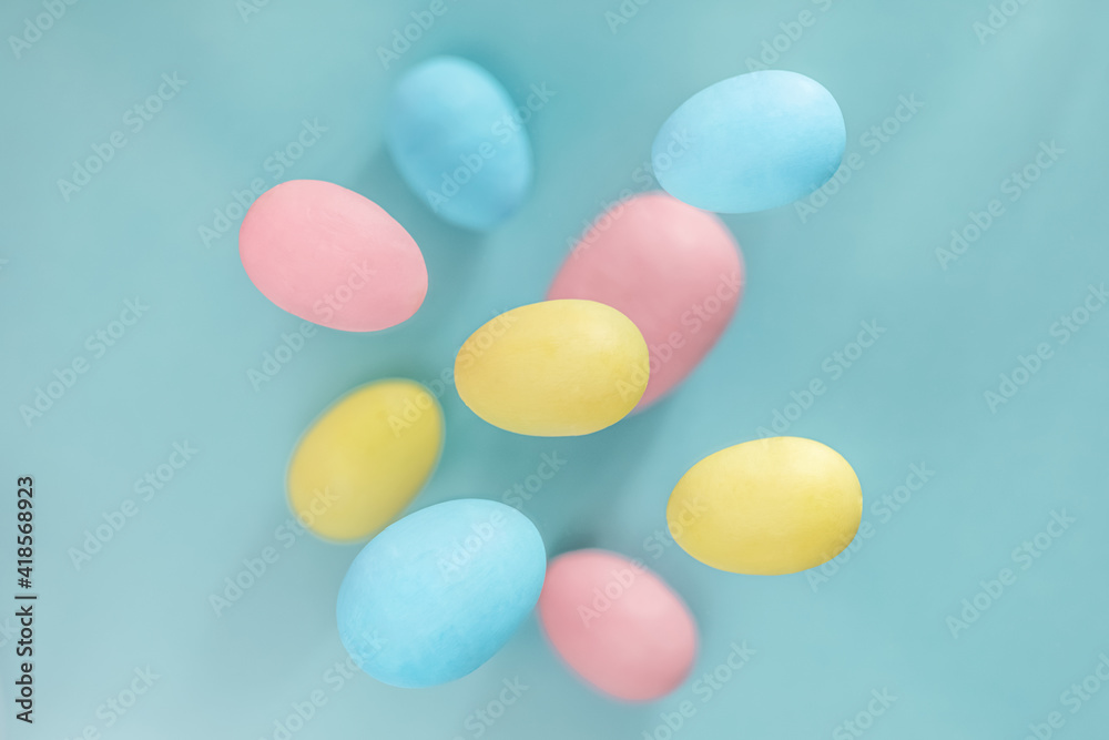 Easter background. Levitating Easter eggs in pastel colors on a blue background. composition of an Easter greeting card, pattern. Easter background. Levitating Easter eggs in pastel colors on a blue background. composition of an Easter greeting card, pattern.