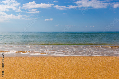 Sea beach with sand and waves. Sunny day.