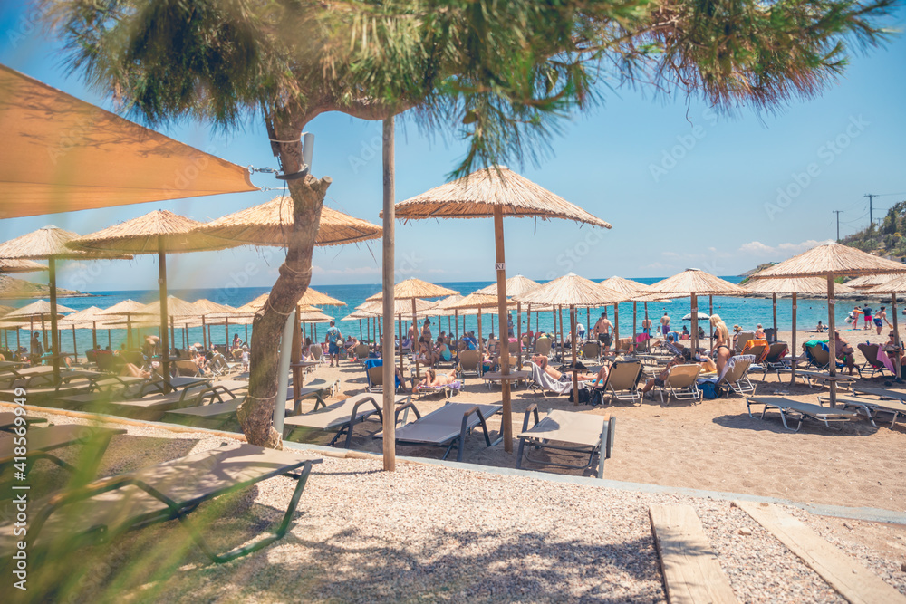Fototapeta premium Beach with umbrellas and chairs
