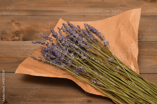 lavender bouquet wrapped in paper on a wooden table