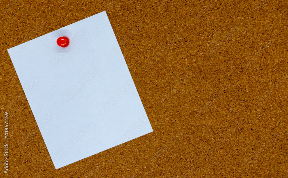 Blank white paper note pinned to a cork board. Copy space Blank white paper note pinned to a cork board. Copy space