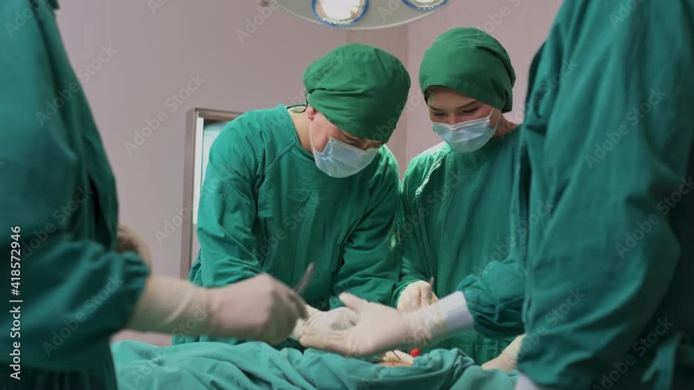 Professional medical team performing surgery in operating room. Professional medical team performing surgery in operating room.