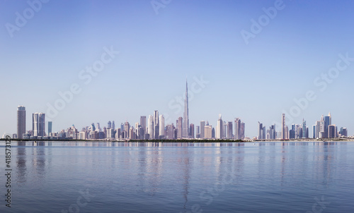Print op canvas Dubai Downtown skyline panorama with reflections in Dubai Creek, cold colors, seen from Dubai Creek Harbour promenade