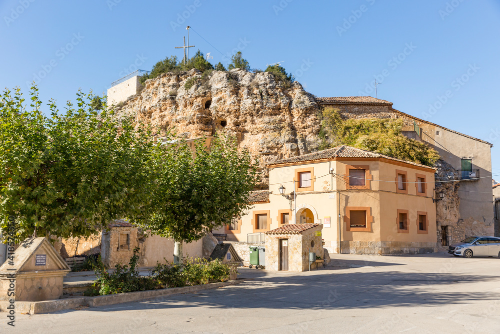 a street with houses built by a cliff in Castillejo de Robledo, province of Soria, Castile and Leon, Spain