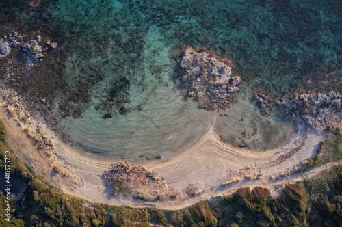 A stretch of coast with sand and turquoise sea, transparent water that allows you to see the seabed.