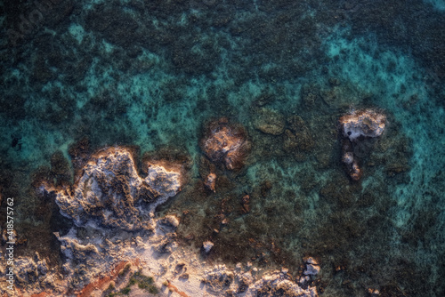 A stretch of coast with turquoise sea, transparent water that allows you to see the seabed.