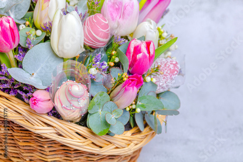 Close-up . Festive fruit basket with flowers, tulips. Concept, congratulations on the holiday, birthday, anniversary. There is a place for text
