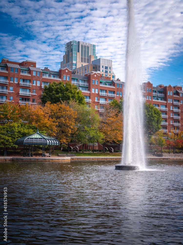 Harmony of Buildings and Nature at Lechmere Canal Park in Boston. High Rising Water Fountain and Pavilion over the Water.
