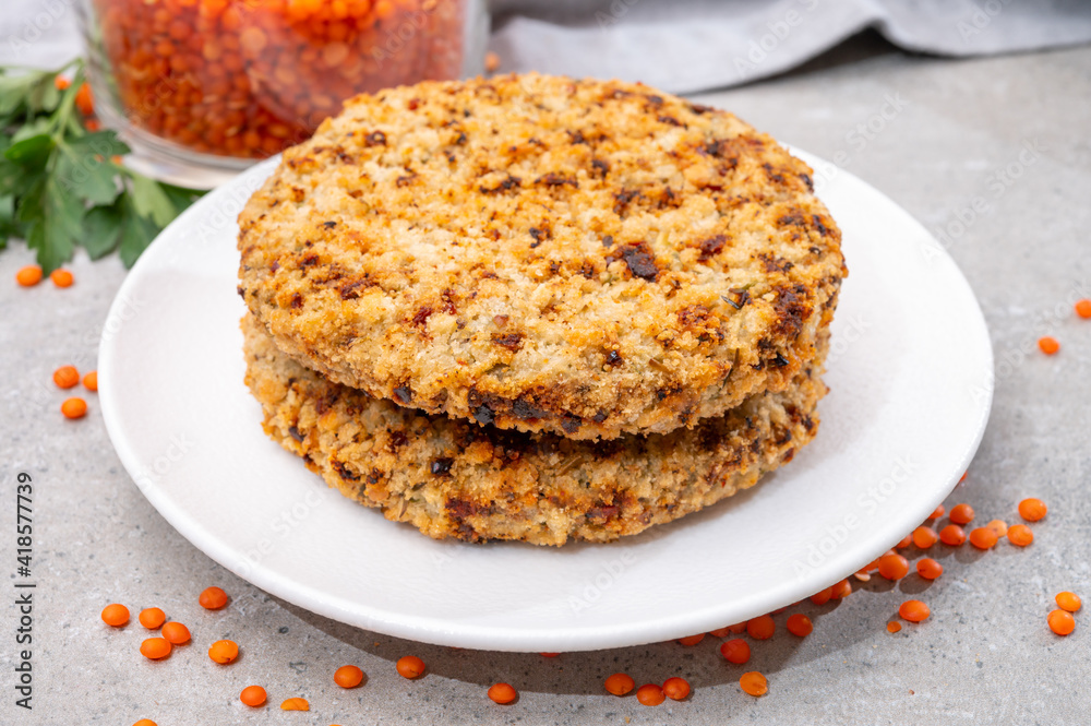 Healthy vegetarian or vegan food, meat free burger made from orange lentils legumes Healthy vegetarian or vegan food, meat free burger made from orange lentils legumes