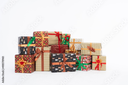 Many colorful gift boxes lie on an isolated white background. Christmas atmosphere.