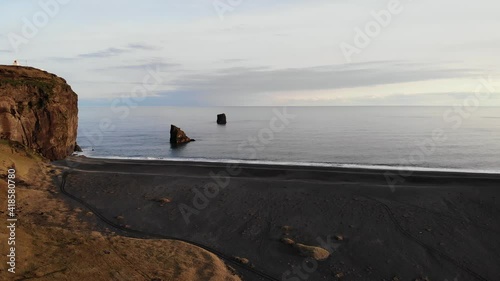 Dyrhólaey / Dyrholaey view point and its surrounding from an aerial drone 4k point of view, around the endless black sand beach during sunset, part4  photo