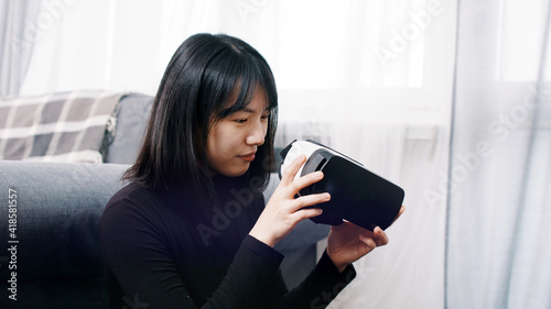 Young asian woman experiencing virtual reality. High quality photo