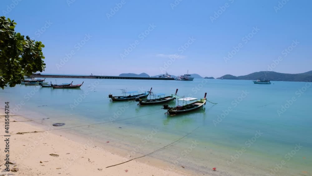 Sea view and Traditional Thai boats for tourist near the beach Thailand. Panwa Bay Phuket. panning shot. Sea view and Traditional Thai boats for tourist near the beach Thailand. Panwa Bay Phuket. panning shot.