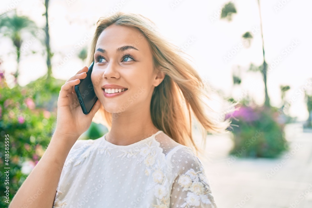 Young caucasian girl smiling happy using smartphone at street of city. Young caucasian girl smiling happy using smartphone at street of city.