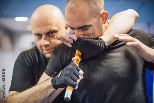 Instructor and student practice filipino escrima stick fighting technique photo