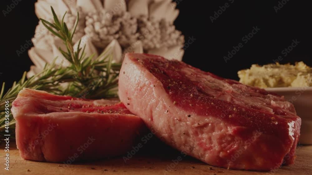 Seasoning the meat, raw Barbecue Rib Eye Steak