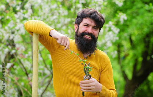 Bearded man with Garden scissors. Work in garden. Spring. Plants. Gardening. Eco-farm.