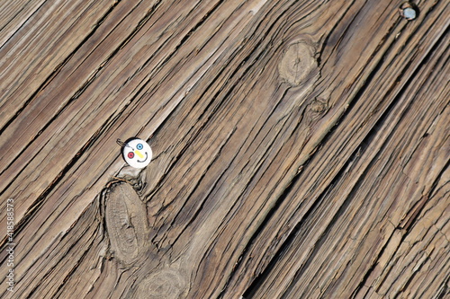 wood background with smile pin