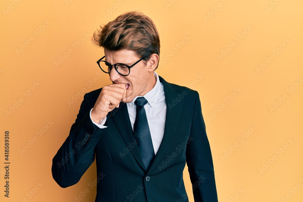 Handsome caucasian man wearing business suit and tie feeling unwell and coughing as symptom for cold or bronchitis. health care concept.