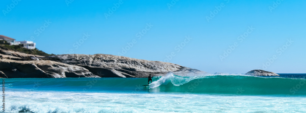 Surfer at Llandudno beach in Cape Town, South Africa