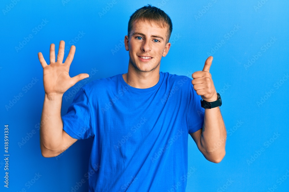 Young caucasian man wearing casual blue t shirt showing and pointing up with fingers number six while smiling confident and happy. Young caucasian man wearing casual blue t shirt showing and pointing up with fingers number six while smiling confident and happy.