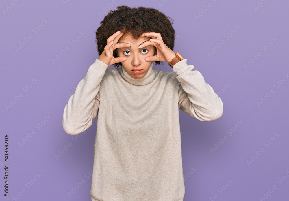 Young hispanic girl wearing wool winter sweater trying to open eyes with fingers, sleepy and tired for morning fatigue Young hispanic girl wearing wool winter sweater trying to open eyes with fingers, sleepy and tired for morning fatigue