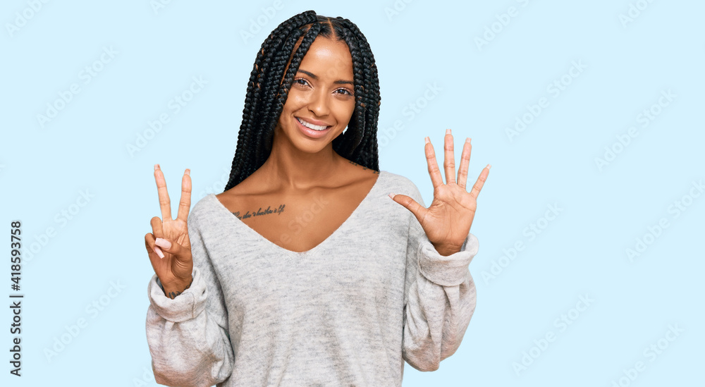 Beautiful hispanic woman wearing casual clothes showing and pointing up with fingers number seven while smiling confident and happy. Beautiful hispanic woman wearing casual clothes showing and pointing up with fingers number seven while smiling confident and happy.